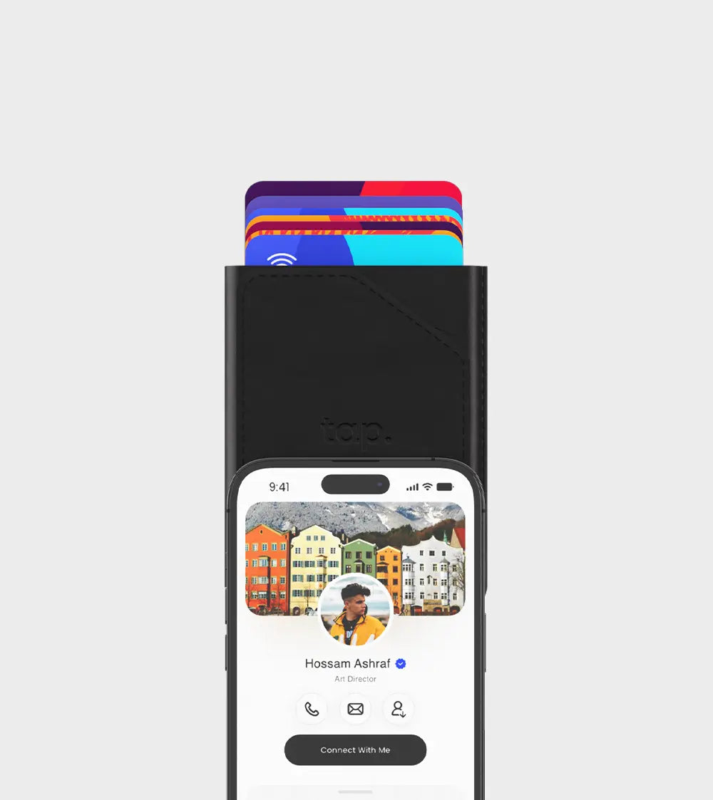 Smartphone with digital business card on screen above a wallet with contactless credit cards.