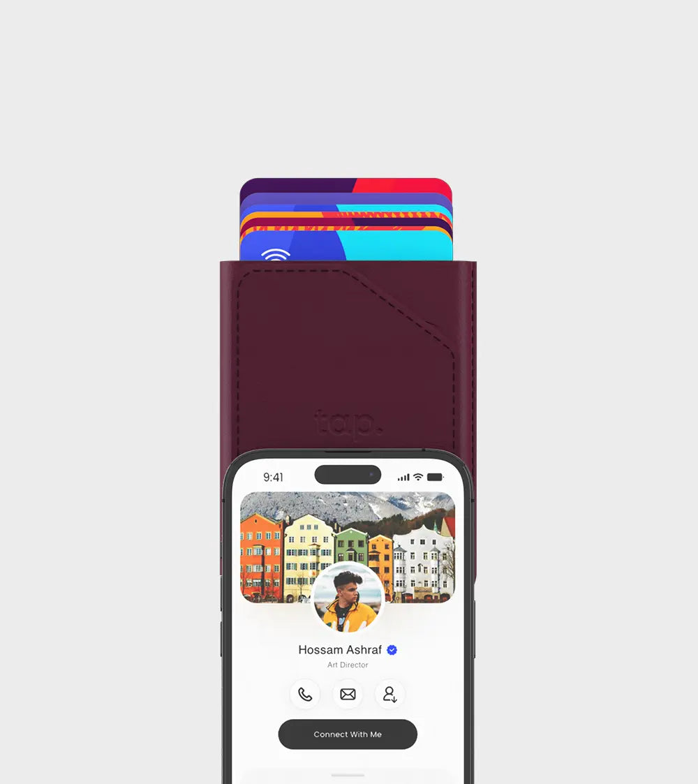 Smartphone with personal profile on screen and leather wallet with contactless credit cards sticking out.