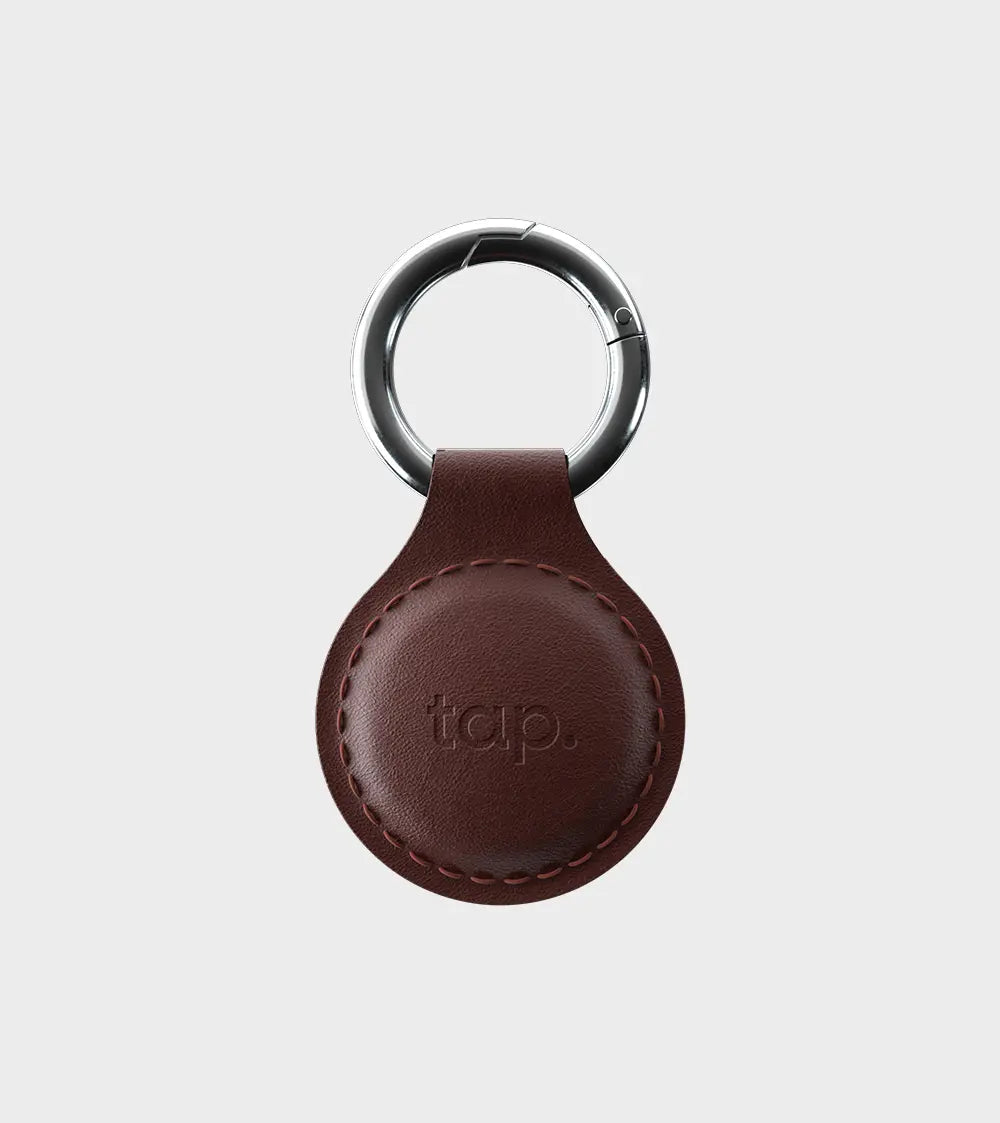 Leather keychain with metal ring and embossed logo on white background
