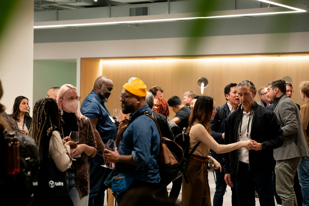 People networking at a busy industry event