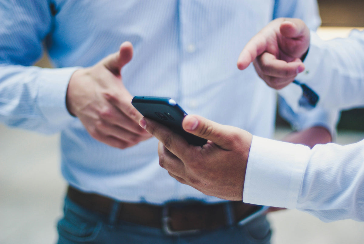 Two professionals sharing details on a phone