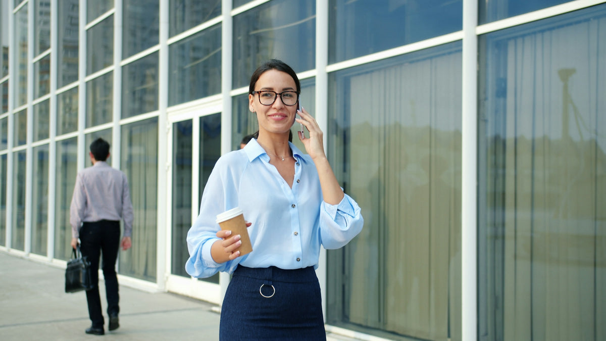 A professional on a phone call outside her office