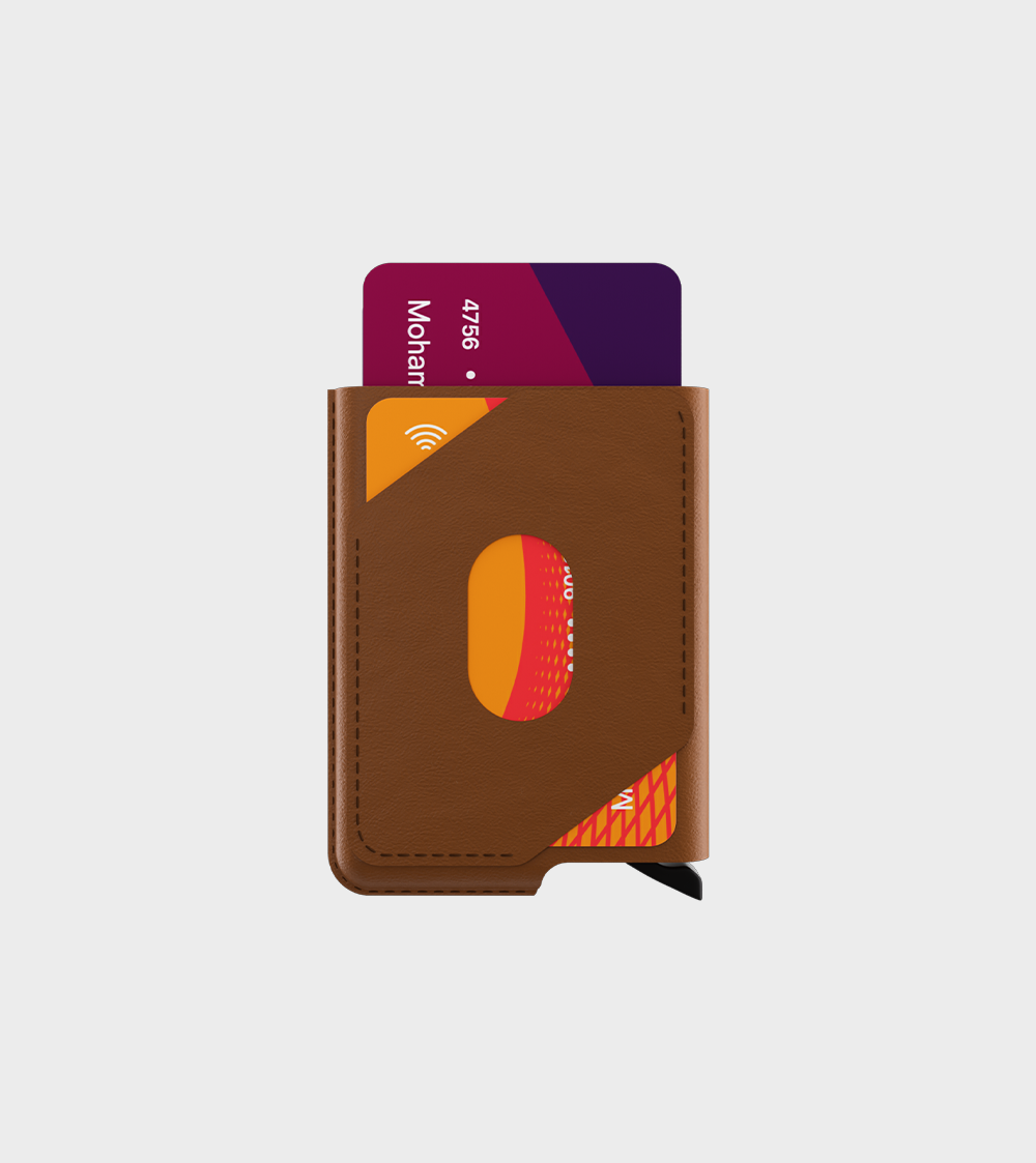 Brown leather wallet with contactless credit cards sticking out on a plain background.