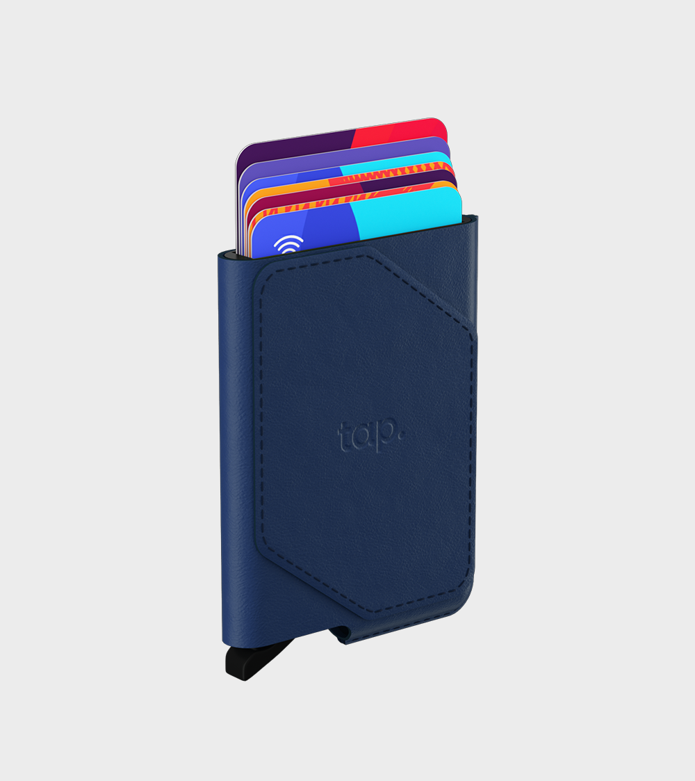 Navy blue leather minimalist wallet with contactless credit cards sticking out on a white background.