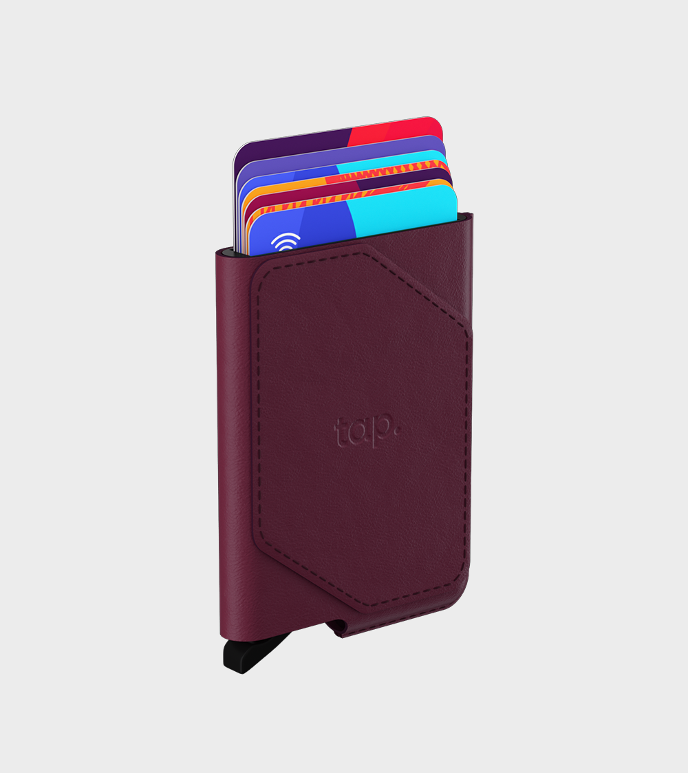 Burgundy slim leather cardholder wallet with multiple colorful cards sticking out on white background.